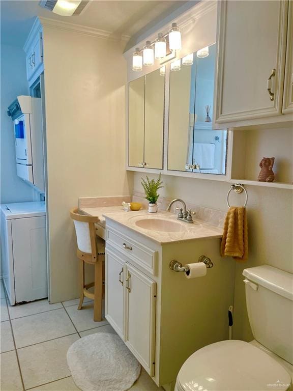 bathroom featuring tile patterned flooring, toilet, washer / dryer, and crown molding