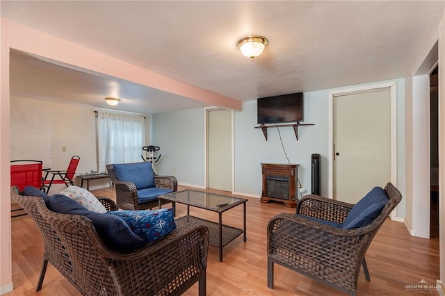 living room with light wood-type flooring and baseboards