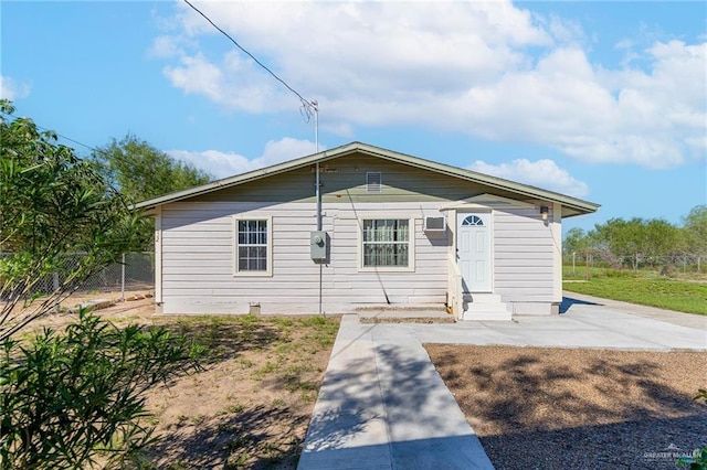 view of front of home with entry steps and fence