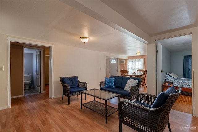 living area featuring light wood-style floors and baseboards