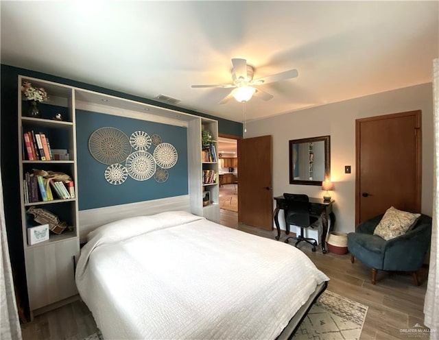 bedroom with hardwood / wood-style floors and ceiling fan