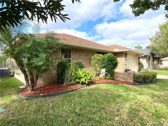 view of side of home featuring a yard, cooling unit, and a garage