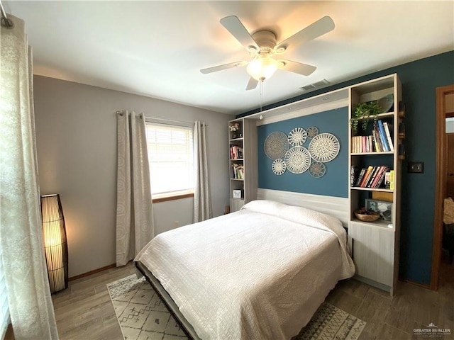 bedroom with wood-type flooring and ceiling fan