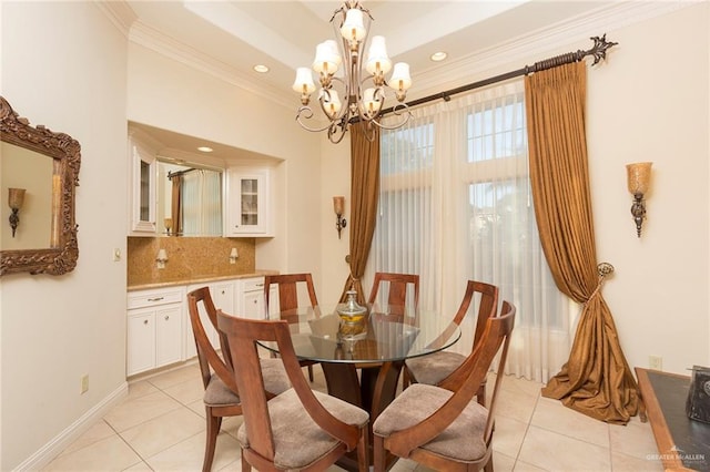 dining area featuring crown molding, light tile patterned floors, and a notable chandelier