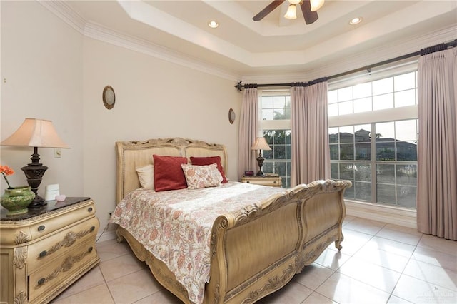 tiled bedroom featuring a tray ceiling, ceiling fan, and ornamental molding