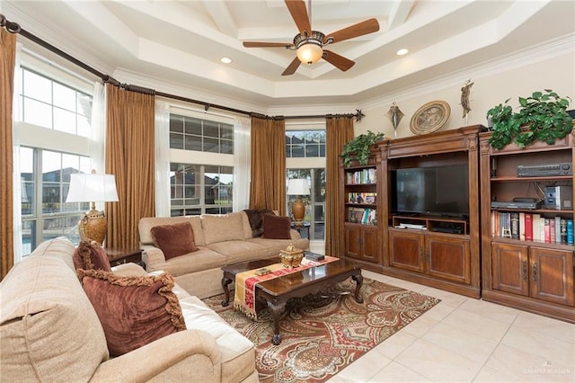 living room featuring a raised ceiling, ceiling fan, crown molding, and light tile patterned flooring