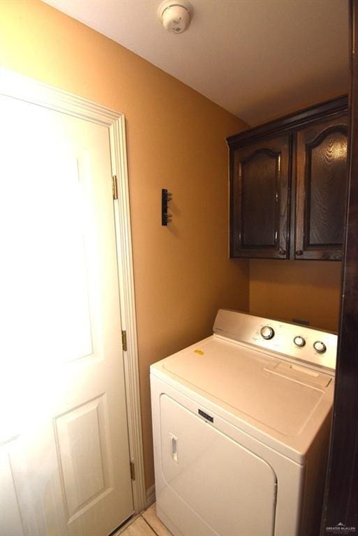 washroom with cabinet space and washer / dryer