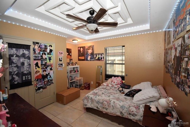 bedroom featuring light tile patterned floors and a raised ceiling