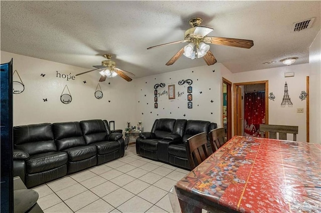 tiled living room with ceiling fan and a textured ceiling