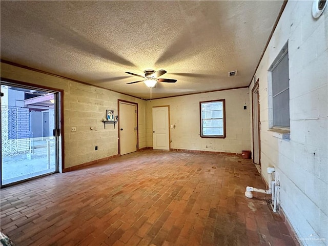 unfurnished room featuring ceiling fan, wood-type flooring, and a textured ceiling