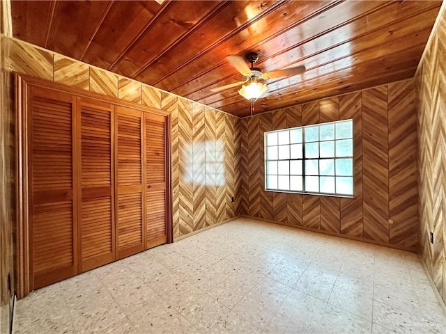 bonus room featuring wooden walls, ceiling fan, and wooden ceiling