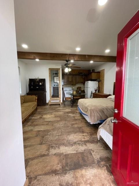 bedroom with ceiling fan and white refrigerator