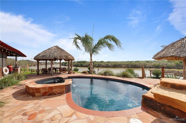 exterior space featuring a gazebo and a water view