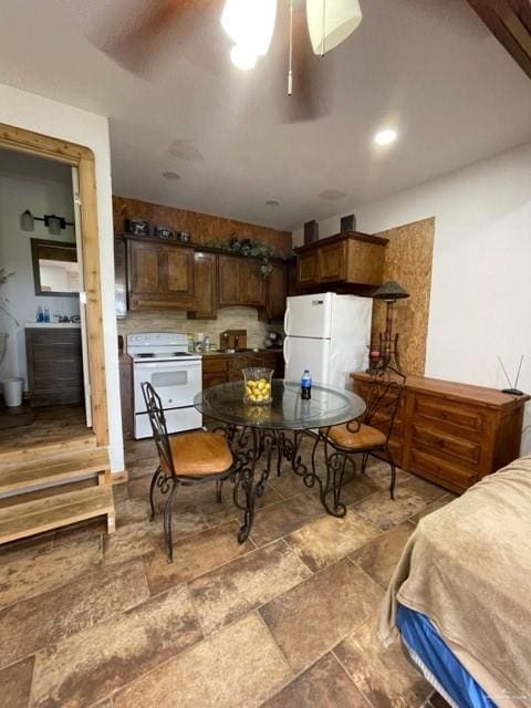 interior space featuring ceiling fan and white appliances