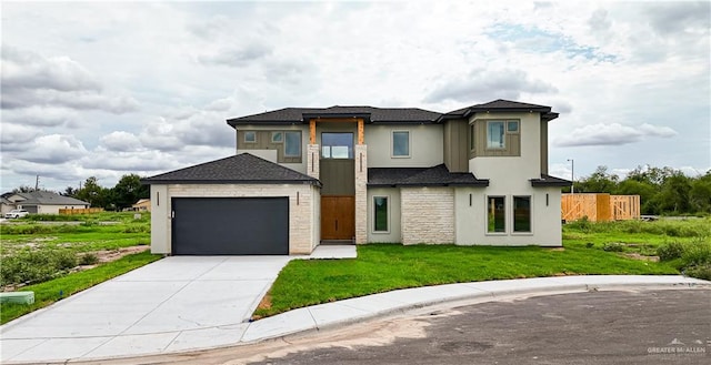 view of front facade featuring a garage and a front lawn