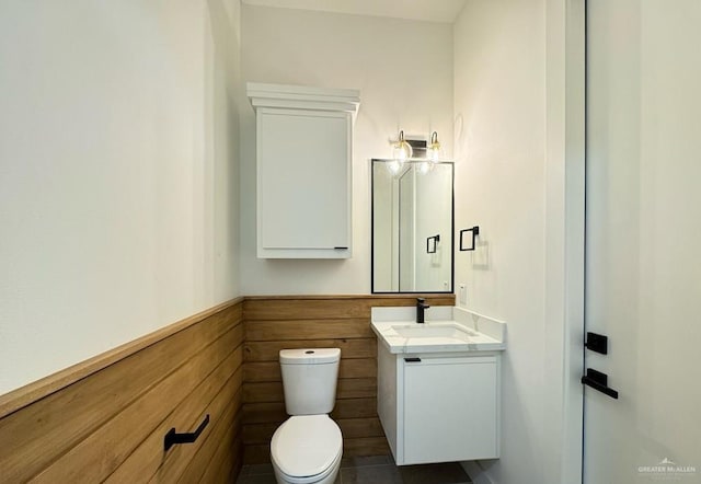 bathroom featuring toilet and vanity