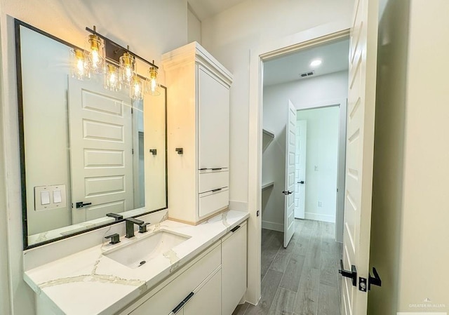 bathroom featuring wood-type flooring and vanity