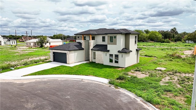 prairie-style house featuring a front lawn and a garage