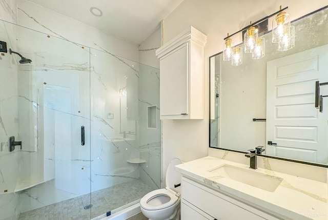 bathroom featuring an enclosed shower, vanity, and toilet