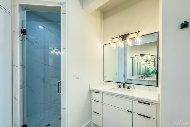 bathroom featuring walk in shower and vanity