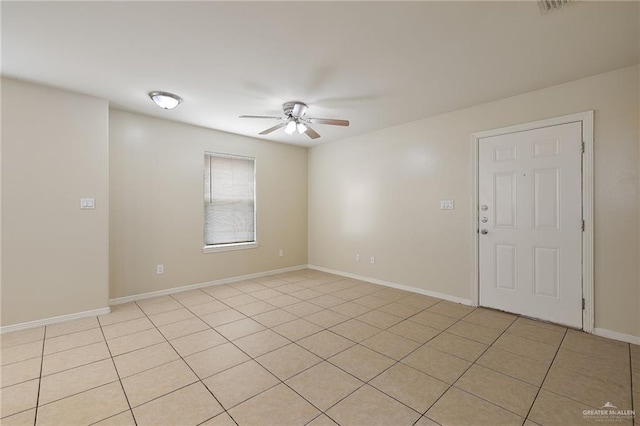 tiled empty room with ceiling fan