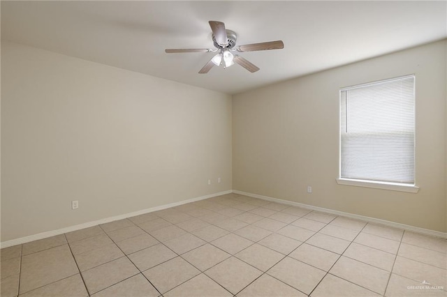 empty room with ceiling fan and light tile patterned floors