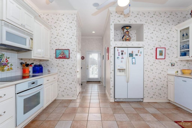 131 E Hibiscus St, South Padre Island, TX 78597 - kitchen featuring white appliances, ornamental molding, light countertops, and wallpapered walls