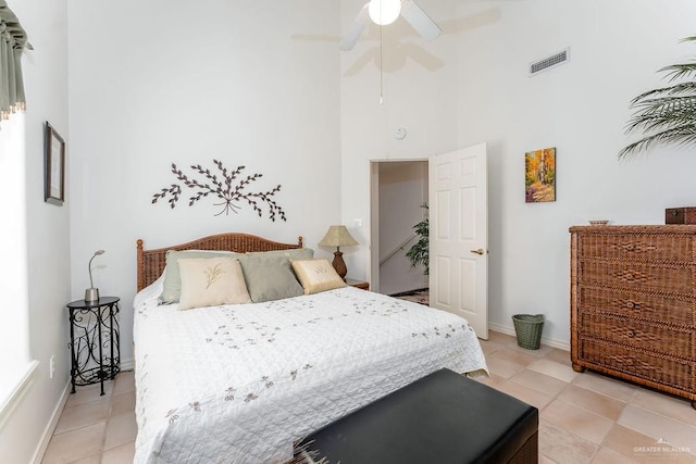 131 E Hibiscus St, South Padre Island, TX 78597 - bedroom featuring light tile patterned floors, a ceiling fan, visible vents, baseboards, and a high ceiling