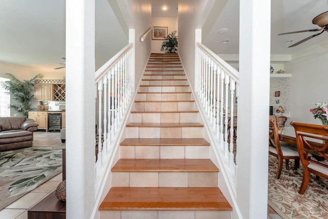 131 E Hibiscus St, South Padre Island, TX 78597 - stairway featuring beverage cooler, tile patterned flooring, a ceiling fan, and ornamental molding