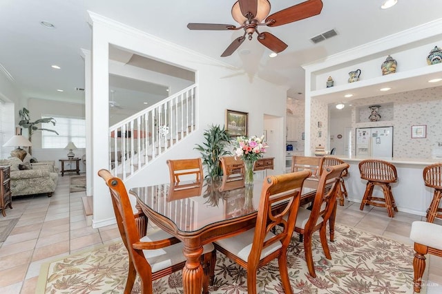 131 E Hibiscus St, South Padre Island, TX 78597 - dining room with stairs, visible vents, a ceiling fan, and crown molding