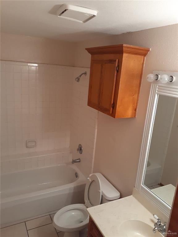 full bathroom with tile patterned flooring, vanity, toilet, and tiled shower / bath