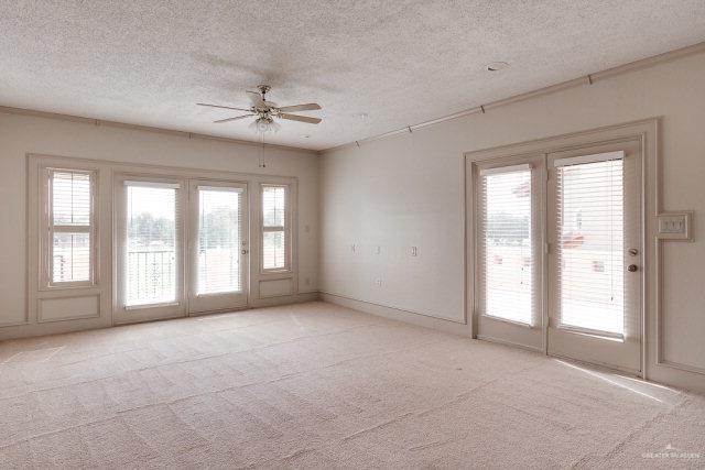 2114 Colorado St, Mission, TX 78572 - spare room featuring ceiling fan, a textured ceiling, light colored carpet, and baseboards
