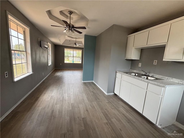 521 E Sherrye Ln, Pharr, TX 78577 - kitchen featuring a sink, a wall mounted AC, dark wood-style flooring, ceiling fan, and baseboards