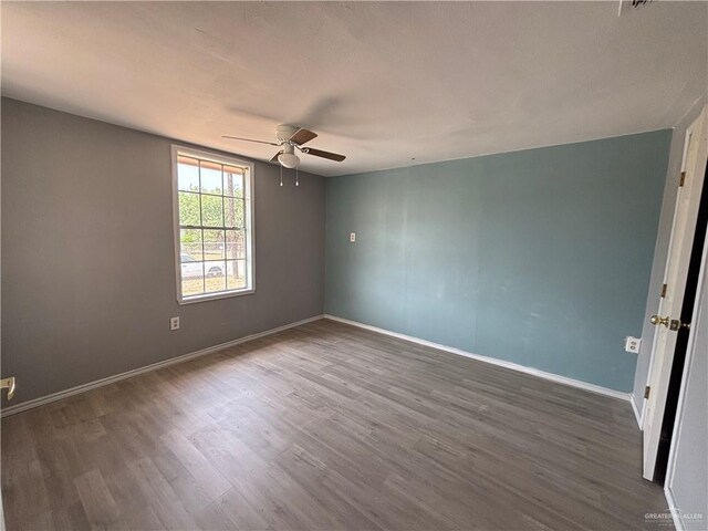521 E Sherrye Ln, Pharr, TX 78577 - empty room featuring a ceiling fan, wood finished floors, and baseboards