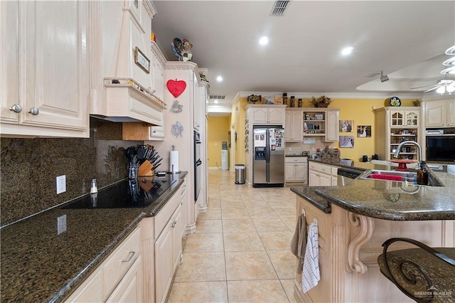 kitchen featuring ceiling fan, sink, tasteful backsplash, light tile patterned floors, and appliances with stainless steel finishes