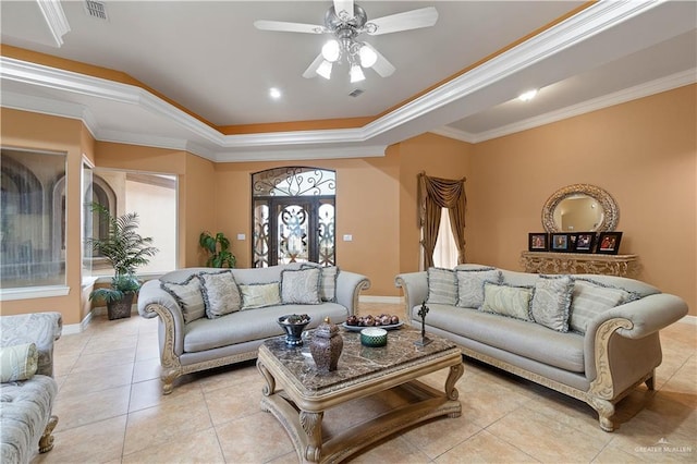 tiled living room with a raised ceiling, crown molding, and ceiling fan