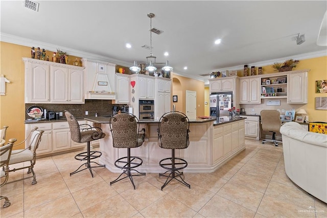 kitchen with a kitchen breakfast bar, stainless steel fridge with ice dispenser, white cabinetry, and a kitchen island