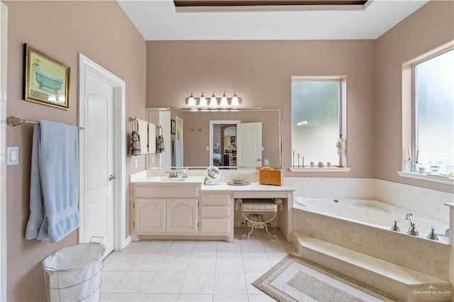 bathroom featuring tile patterned flooring, vanity, a tub to relax in, and a wealth of natural light