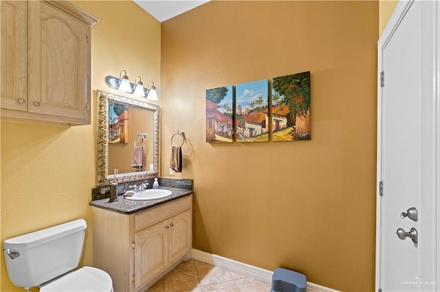 bathroom featuring toilet, vanity, and tile patterned floors