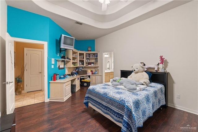 bedroom with dark hardwood / wood-style flooring, ensuite bath, and ceiling fan