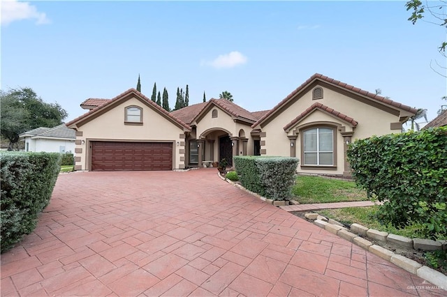 mediterranean / spanish-style home featuring a garage