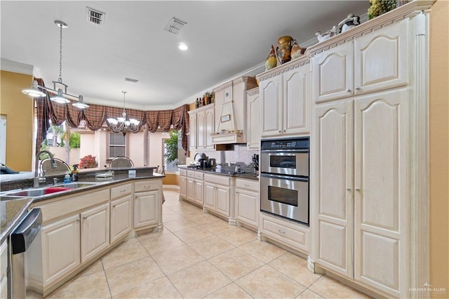 kitchen featuring sink, decorative light fixtures, ornamental molding, a notable chandelier, and stainless steel appliances