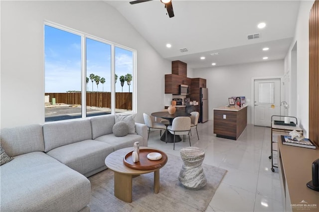 living room featuring ceiling fan and lofted ceiling