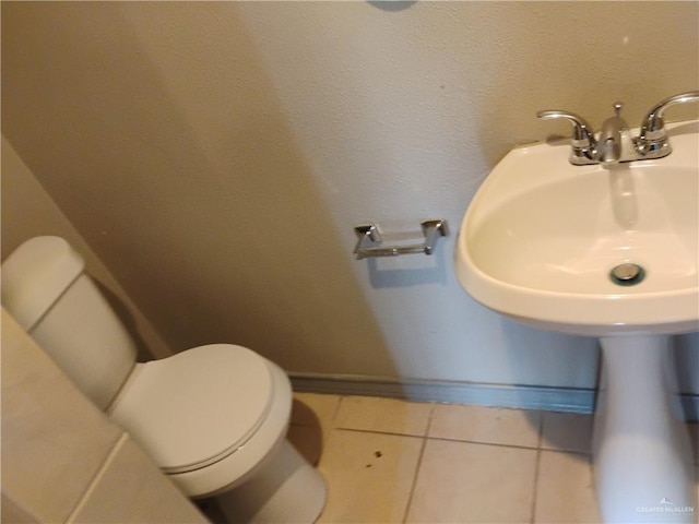 bathroom with tile patterned flooring and toilet