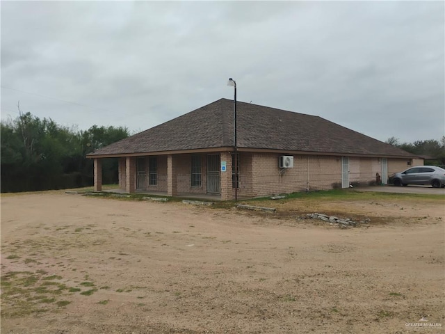 back of house featuring a porch