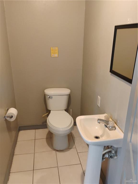 bathroom with tile patterned flooring and toilet