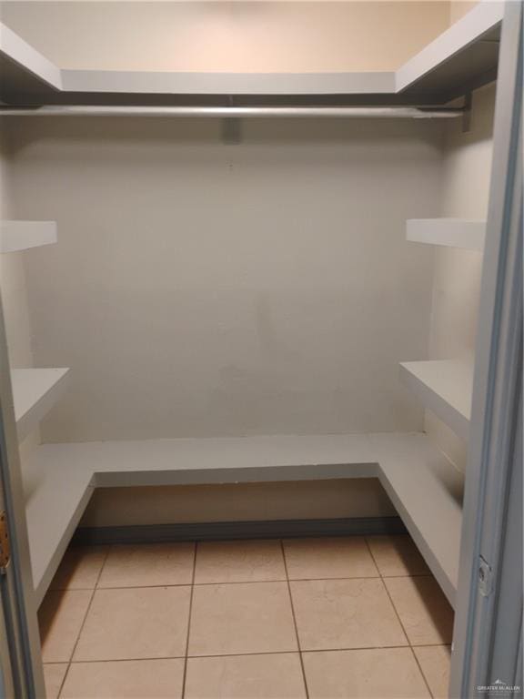 spacious closet featuring light tile patterned floors