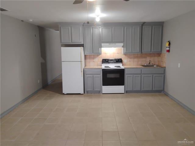 kitchen with gray cabinetry, ceiling fan, sink, white appliances, and decorative backsplash