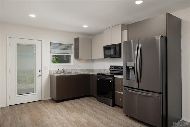 1615 W B St, Mission, TX 78572 - kitchen with stainless steel appliances, a sink, light wood-style floors, recessed lighting, and light stone counters