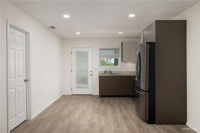 1615 W B St, Mission, TX 78572 - kitchen featuring freestanding refrigerator, a sink, light wood-style floors, recessed lighting, and modern cabinets